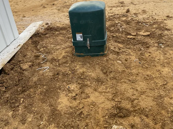 Pad mounted transformer beside a finished building