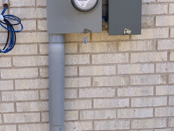 Meter base and disconnect mounted on a brick wall