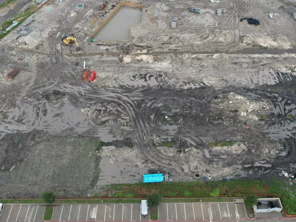 Aerial view of the graded site with the pool under construction