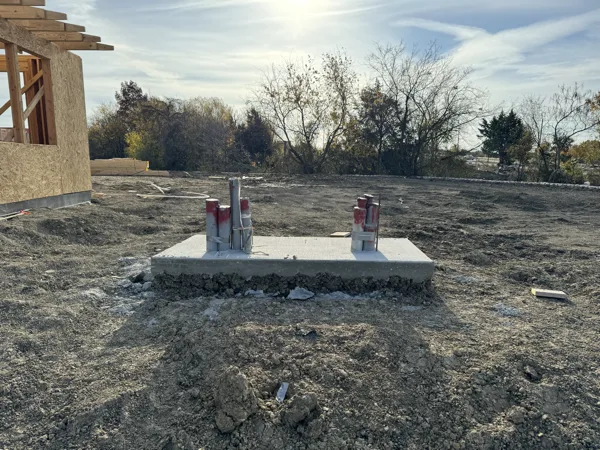 Concrete transformer pad with conduit stub ups on a graded site