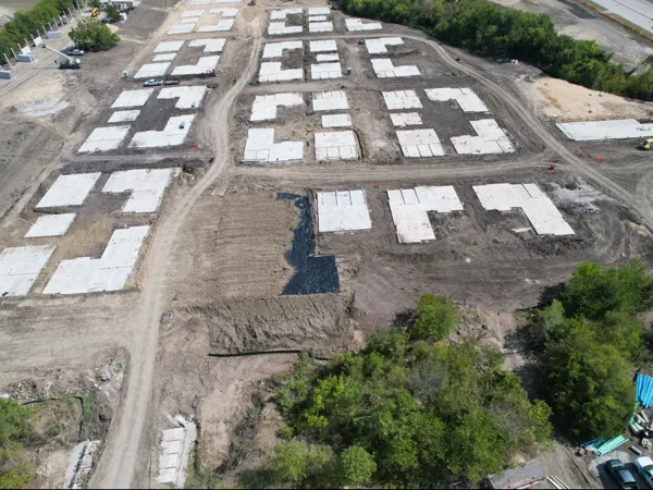 Aerial view of building slabs laid out across the site