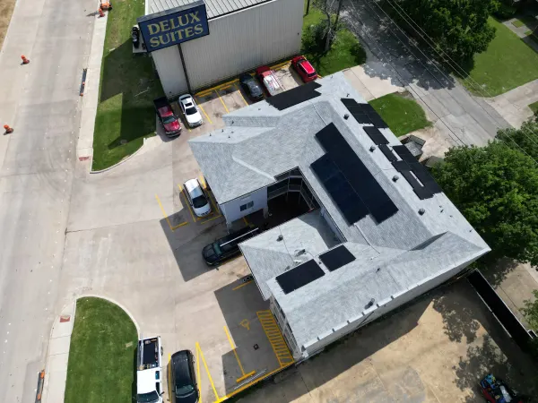 Aerial view of a 20 kW rooftop solar array on the Delux Suites hotel in Irving, Texas