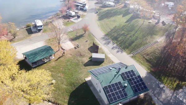 24.5 kW solar array on the green metal roof of a lakeside campground shower house at Seneca Lake, Ohio