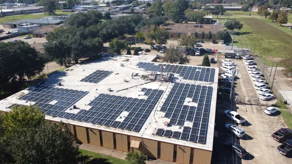 Aerial view of a 160.6 kW rooftop solar array covering a flat-roof commercial building in Alexandria, Louisiana