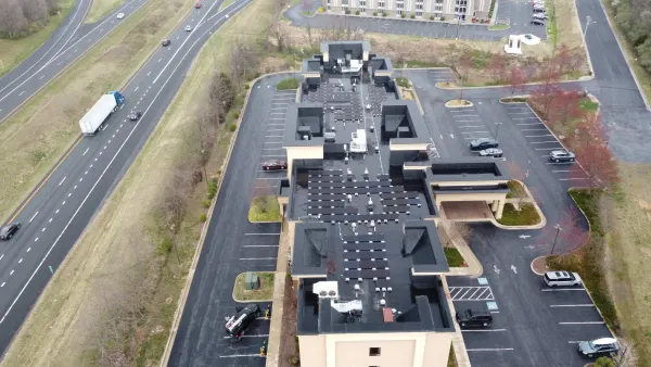 50 kW solar array across the flat roofs of a Hampton Inn beside the interstate in Woodstock, Virginia