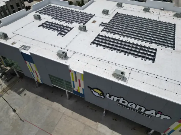 122 kW rooftop solar array on the white membrane roof of an Urban Air indoor park in Houston, Texas